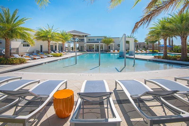 Photo of the zero-entry resort pool with the clubhouse behind it